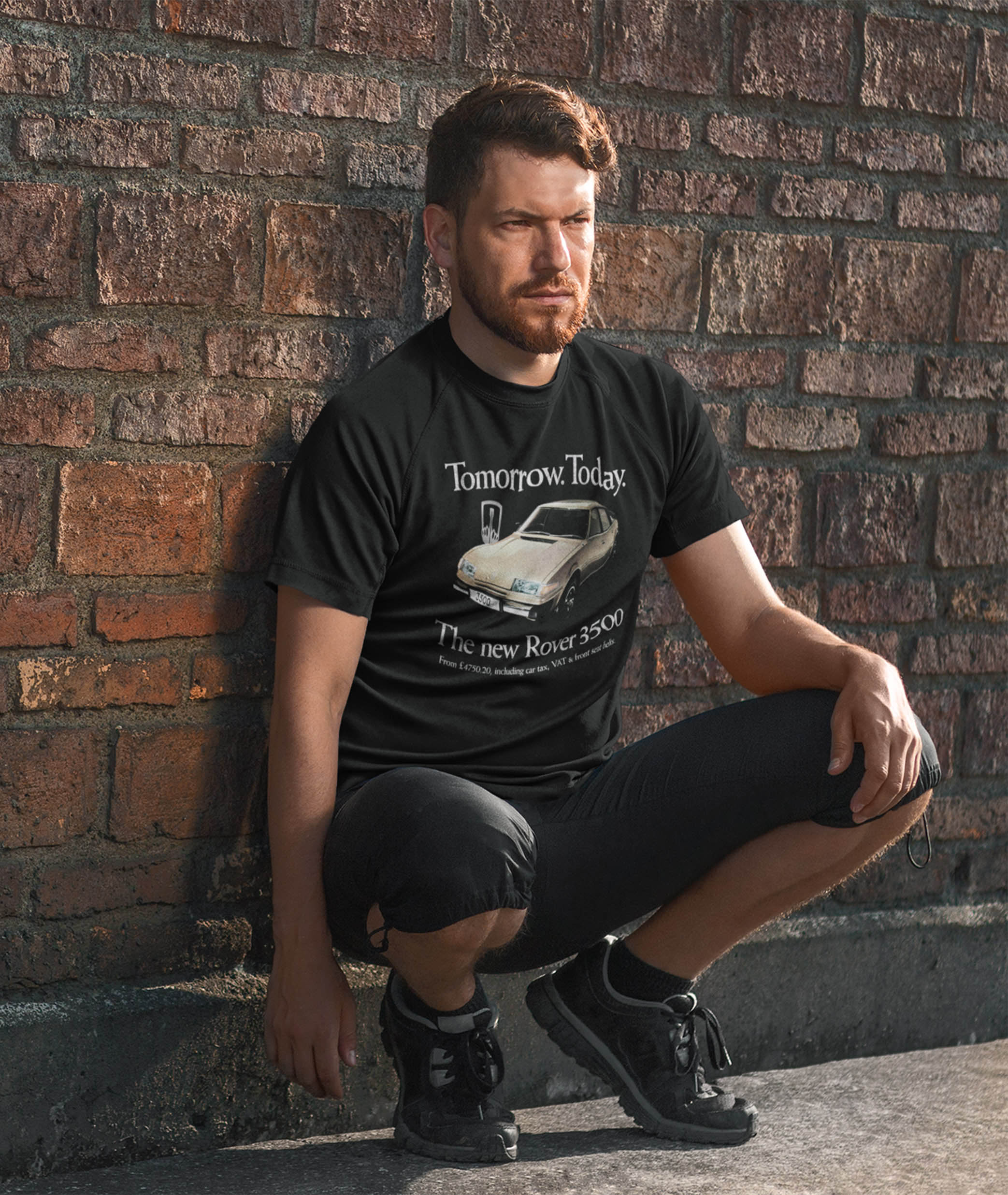 Man leaning on a wall wearing a black Rover 3500 SD1 t shirt